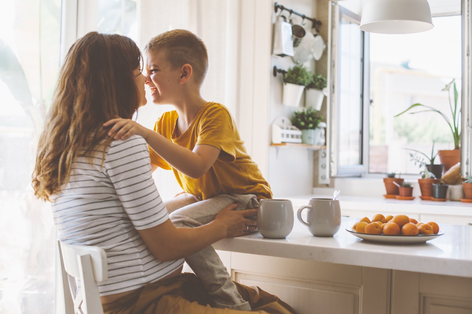 Pregnant Mom with Kid Playing Together in the Kitchen